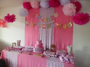 Mesa de aniversário com toalha rosa